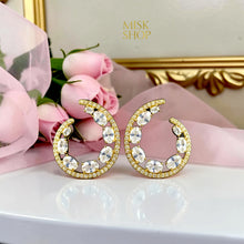 Gold open teardrop earrings detail
