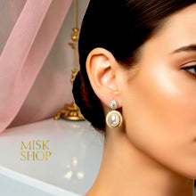 18K gold plated oval cultured pearl drop earring with high-transparency zircon halo worn on a model