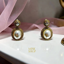 Close-up of oval cultured pearls framed by high-transparency zircon halos with smaller embellished tops