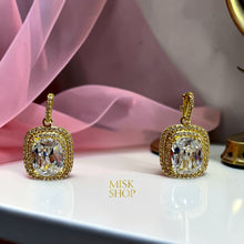 Close-up of 18K gold plated rectangular zircon halo drop earrings