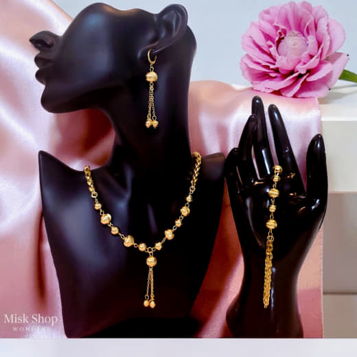 Luxury gold jewelry set with necklace, bracelet, and dangling earrings by Misk Shop