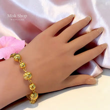 Luxury gold jewelry set with necklace, bracelet, and dangling earrings by Misk Shop