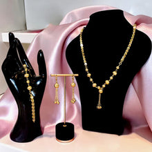 Luxury gold jewelry set with necklace, bracelet, and dangling earrings by Misk Shop