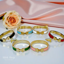 Wide gold plated H style bangle available in six colors from Misk Shop

