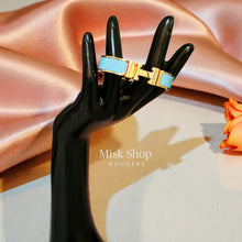 Wide gold plated H style bangle available in six colors from Misk Shop
