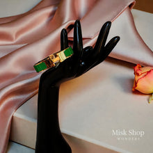 Wide gold plated H style bangle available in six colors from Misk Shop
