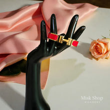 Wide gold plated H style bangle available in six colors from Misk Shop
