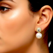 18K gold plated cultured pearl drop earring with rounded-square zircon top worn on a model