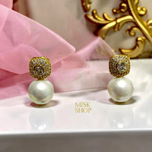 Close-up of cultured pearl drop earrings with high-transparency zircon rounded-square tops