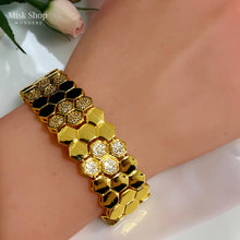 Close-up of alternating polished hexagonal links and zircon-set honeycomb clusters
