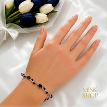 Silver-tone navy zircon tulip bracelet styled on the wrist