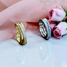 Gold and silver open crossover rings with clear stone detailing
