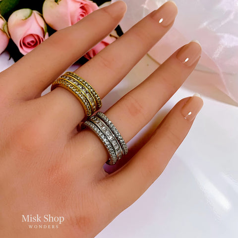 Gold and silver open zirconia rings worn on hand