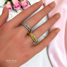 Gold and silver open wedding rings with zirconia worn on hand
