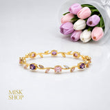 Gold-tone tulip vine bracelet with pink and lilac zircon stones