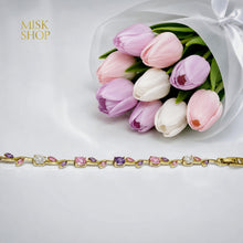 Full-length gold-tone bracelet with alternating pink and lilac zircon stones