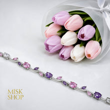 Full-length silver-tone bracelet with alternating pink and lilac zircon stones