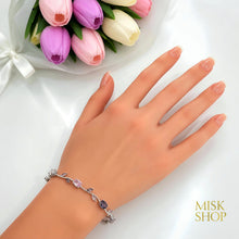 Silver-tone pink and lilac zircon bracelet styled on the wrist