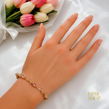 Gold-tone pink zircon tulip bracelet styled on the wrist