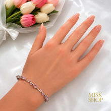 Silver-tone pink zircon tulip bracelet styled on the wrist