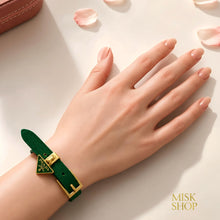 Green Prada triangle-logo adjustable leather bracelet worn on wrist