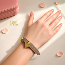 Tan Prada triangle-logo adjustable leather bracelet worn on wrist