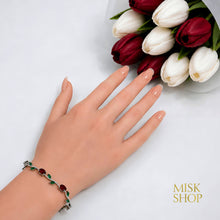 Silver-tone red and green zircon tulip bracelet styled on the wrist