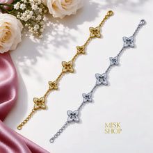 Gold and silver floral zircon bracelets displayed together