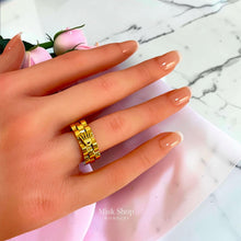 Gold Rolex-inspired ring shown on hand