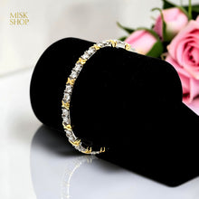 Two-tone zircon bangle displayed on black stand
