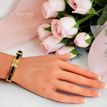 Misk Shop Tory Burch inspired 18K gold plated black enamel bangle styled on a hand