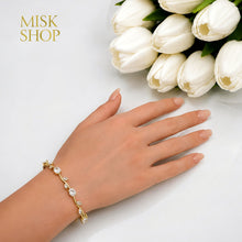 Gold-tone clear zircon tulip bracelet styled on the wrist
