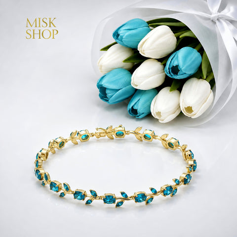 Gold-tone tulip vine bracelet with turquoise zircon stones