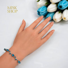 Silver-tone turquoise zircon tulip bracelet styled on the wrist