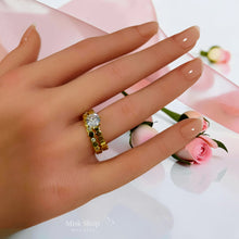 Gold twin zircon ring set shown on hand