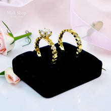Gold twin wedding ring set on display